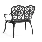 Outdoor metal bench with floral rose design in black finish on a patio