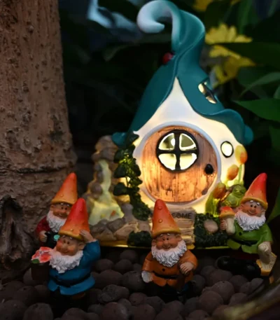 Solar garden gnome glowing at night in a flower bed