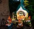 Solar garden gnome glowing at night in a flower bed