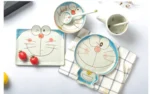 Japanese ceramic dinnerware set with hand-drawn cat design on blue rectangular plate and bowl