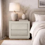 Whitewashed oak nightstand with two drawers in modern minimalist style beside a bed in a bedroom