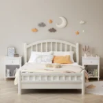 White wooden nightstand with one drawer and one shelf, 26.77 inches tall, placed beside a bed