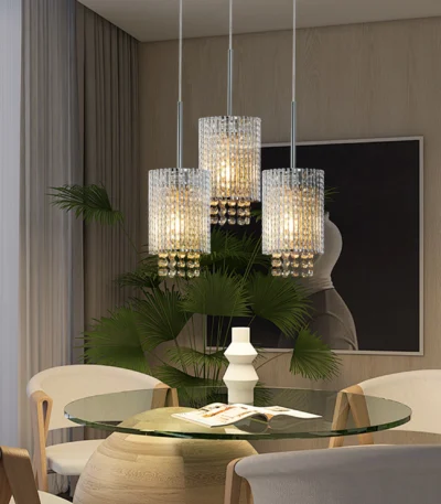 Chrome spiral pendant light with crystal stripes hanging over a modern kitchen island, bright ambient lighting.