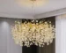 Modern crystal chandelier tree branch design illuminating a dining room