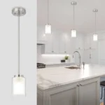 ETL brushed nickel mini pendant light with dual glass shades over a dining table in a modern kitchen.
