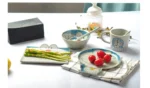 Japanese ceramic dinnerware set with hand-drawn cat design on blue rectangular plate and bowl