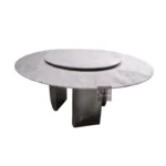 Modern round dining table with white marble top and gold stainless steel base in a bright dining room