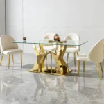 Modern glass dining table with stainless steel legs and clear tempered glass top