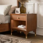 Modern nightstand with USB port and gold capped legs in walnut finish
