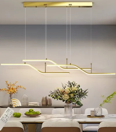 Modern 3-light LED pendant light in black, hanging above a wooden dining table in a bright room.