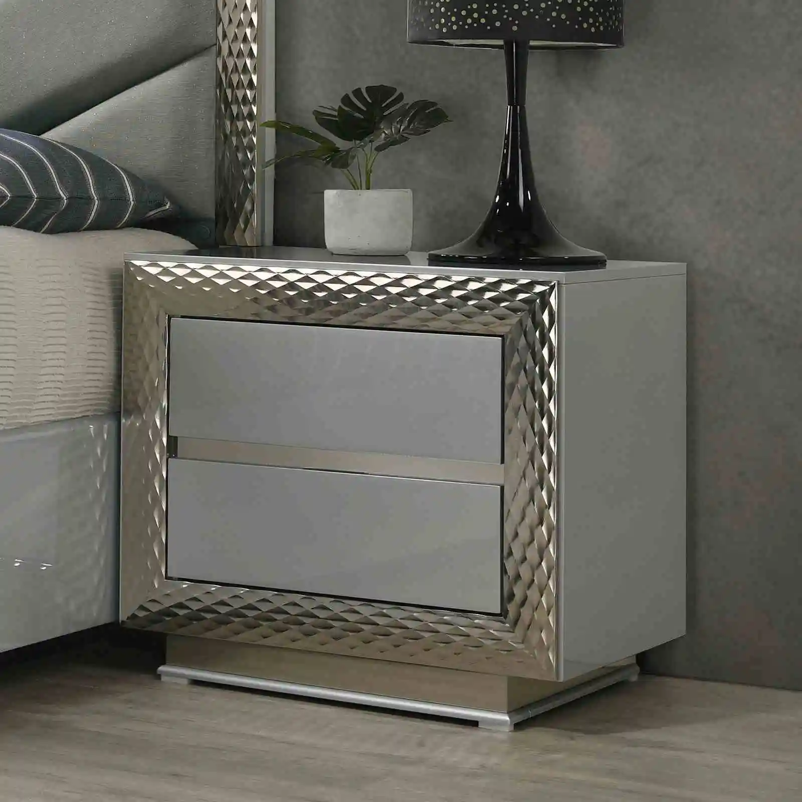 H0b1306b213884f9bbdaf21774fb4464fb.webp Modern gray nightstand with felt lined top drawer and silver molding plinth base - Goldoma bedroom furniture