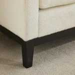 Goldoma upholstered bench daybed ottoman with wood legs and two bolster pillows in a modern living room setting