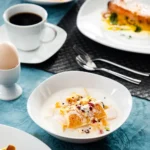 Elegant 50-piece porcelain tableware set by MALACASA Elisa series on a dining table