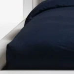 Goldoma black tufted faux leather king bed frame in modern bedroom setting