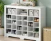 Modern shoe storage cabinet with 24 cubbies and curved base in a living room