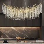 Modern large crystal chandelier in gold finish hanging over dining table