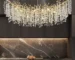 Modern large crystal chandelier in gold finish hanging over dining table