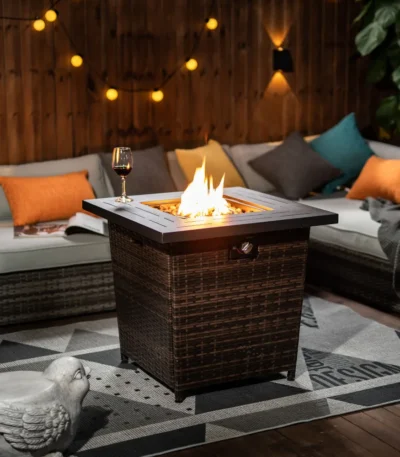 Square propane fire pit table with wicker base on patio