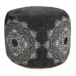 Goldoma 18-inch foldable pouf ottoman in black cotton with white medallion pattern, showcased in a living room as a stylish footrest