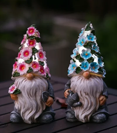 Solar garden gnome glowing in a flower bed at dusk