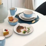 Elegant stoneware dinner set for 4 with embossed pattern on a wooden table