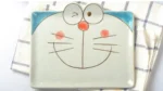 Japanese ceramic dinnerware set with hand-drawn cat design on blue rectangular plate and bowl