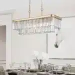 Detailed view of E12 candle bulbs and crystal accents on the industrial chandelier, set in a rustic farmhouse room.