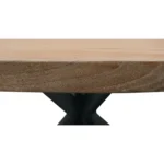 Rustic round dining table with natural acacia wood top and black iron pedestal base in a farmhouse dining room
