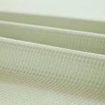 Modern grid sage green shower curtain with waterproof PEVA material in a bright bathroom