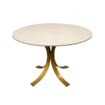 Elegant round marble dining table with ivory marble top and brass pedestal base in a modern dining room