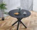 42-inch round mirrored dining table with matte black metal base in a modern dining room
