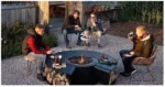 Outdoor fire pit chimnea on patio with flames and grill grate