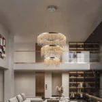 Close-up of the chandelier's K9 crystal layers, showing clear glass and chrome finish under bright light.