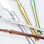 Goldoma 16-piece stainless steel silverware set with forks, knives, and spoons on a wooden table