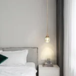 Adjustable metal arm of Goldoma 5W Mini LED pendant light, angled over dining table
