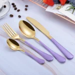 Elegant gold flatware set with fork, knife, and spoon on a white tablecloth