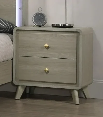 Modern nightstand with USB port and gold capped legs in bedroom setting