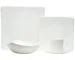 Elegant dinnerware set on white table with gold rimmed plates and bowls
