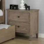 Wire brushed warm gray nightstand with two drawers and round knobs in a bedroom setting