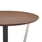 48-inch round two tone dining table with brown wood top and black iron sled base in a dining room setting