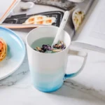 Nordic gradient blue ceramic dessert plates set with bowls and cups on a wooden table