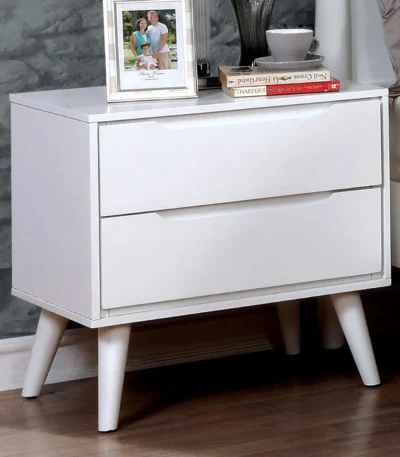 Modern white nightstand with 2 drawers and tapered legs in a bedroom setting