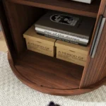 Modern cylinder end table with built-in charging station and sliding door storage