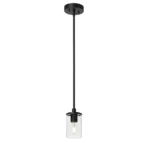Single pendant light casting light on a dining table, with a clear glass globe and black accents.