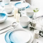 Nordic gradient blue ceramic dessert plates set with bowls and cups on a wooden table
