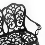 Outdoor metal bench with floral rose design in black finish on a patio