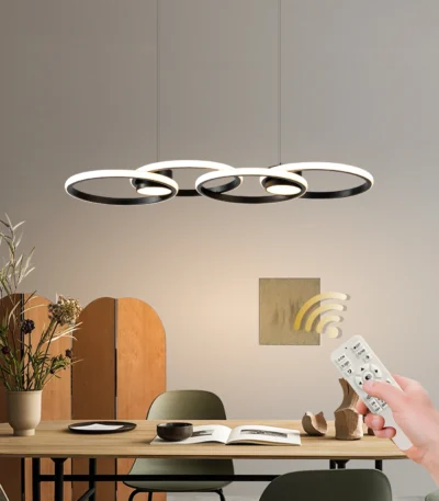 4-Ring LED Pendant Light in black metal, dimmable modern chandelier hanging above a dining table in a contemporary