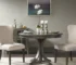 Modern round dining table in solid wood with grey finish in a cozy dining room setting