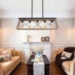Goldoma 32-inch industrial 5-light pendant chandelier with black metal cage, hanging over a modern dining table.