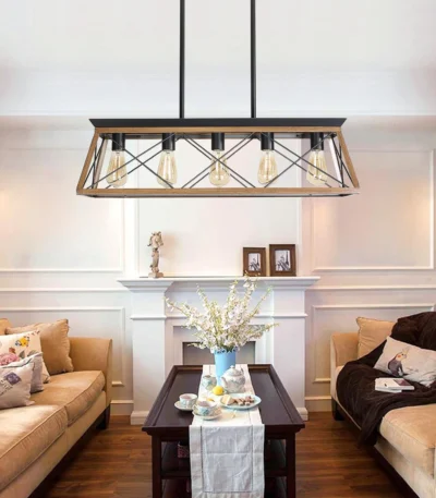 Goldoma 32-inch industrial 5-light pendant chandelier with black metal cage, hanging over a modern dining table.